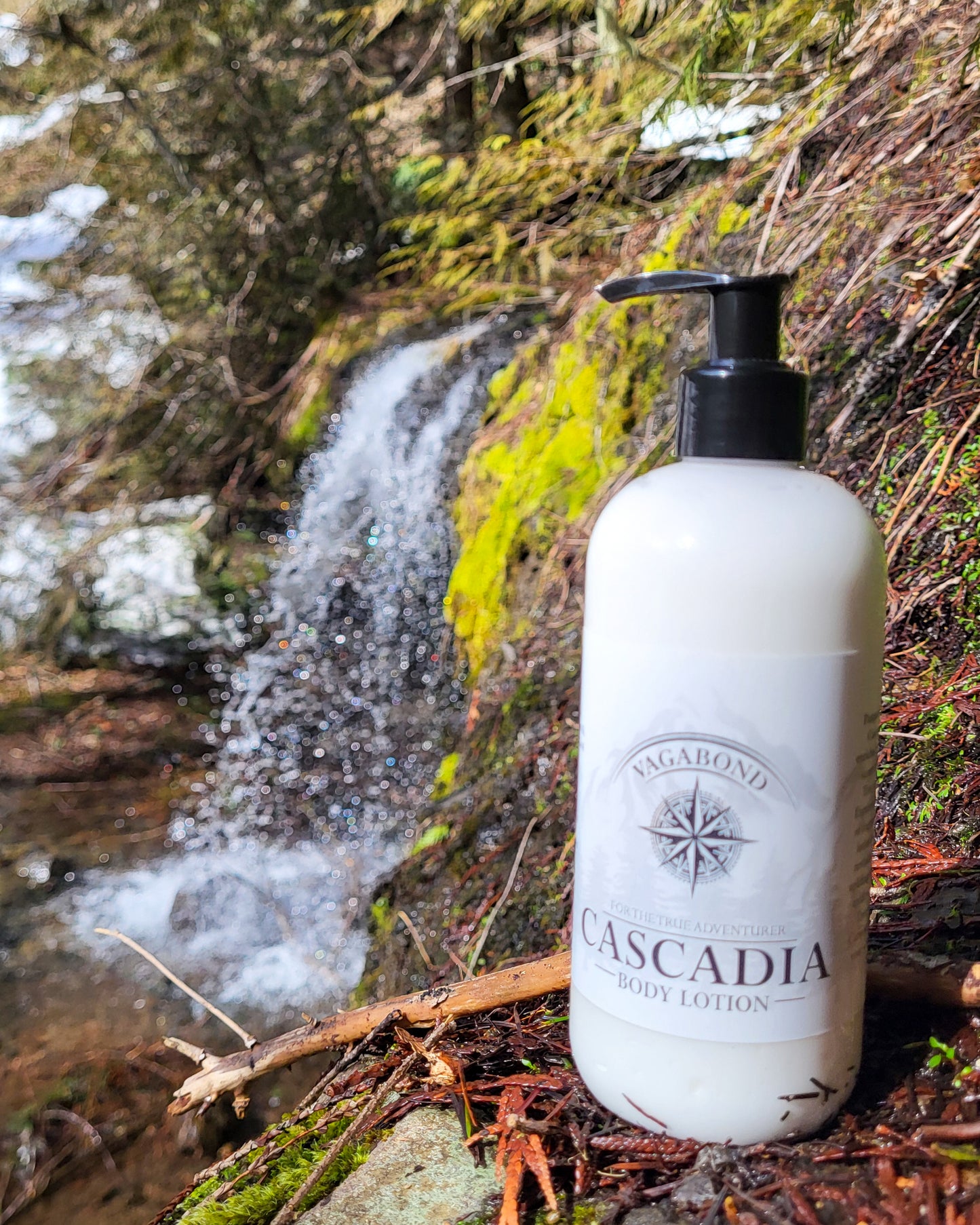 Cascadia natural lotion lemon citrus scent displayed on a mountainside against a blurry waterfall backdrop.