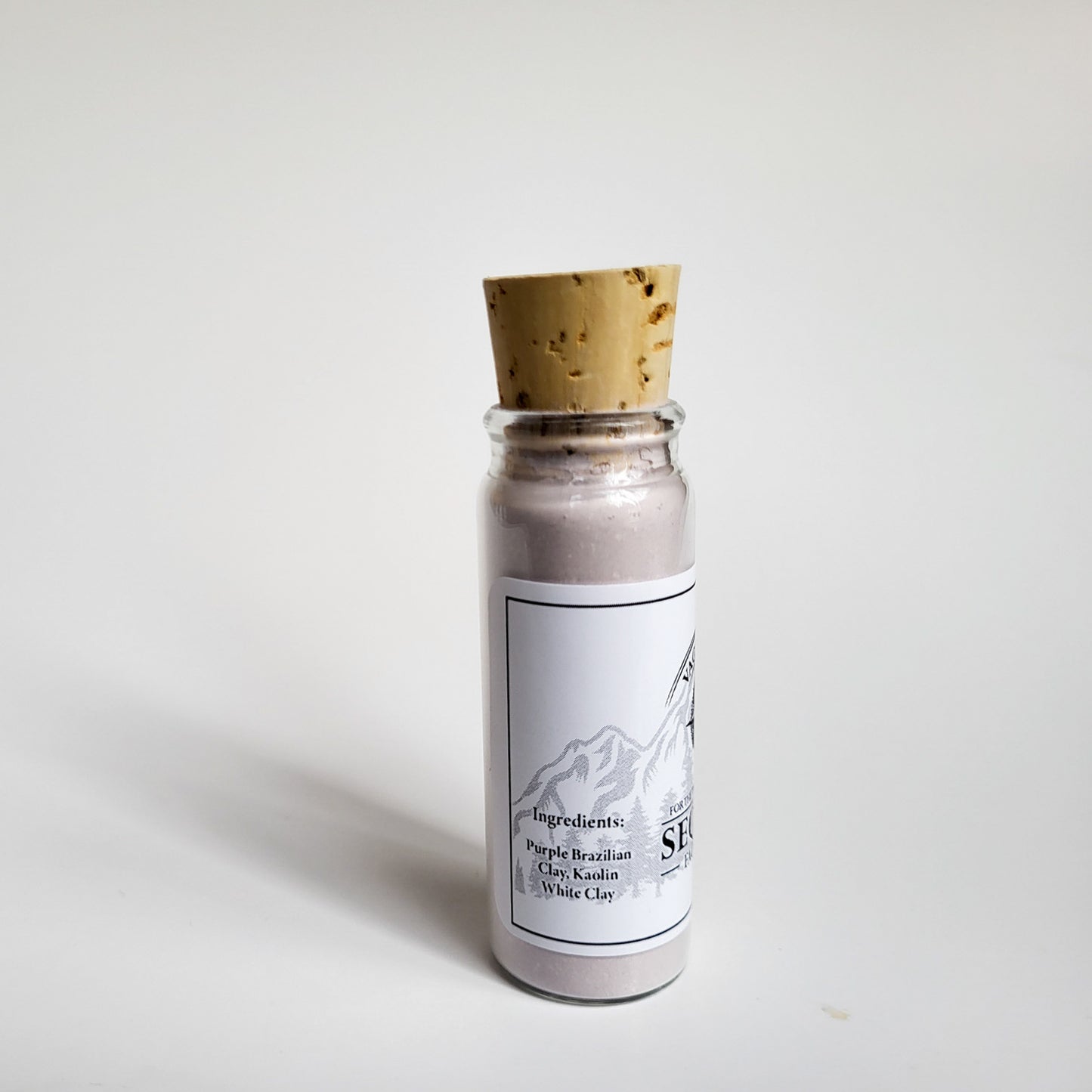 Sequim natural clay mask in corked glass bottle displayed against a plain white backdrop showing ingredients on the label