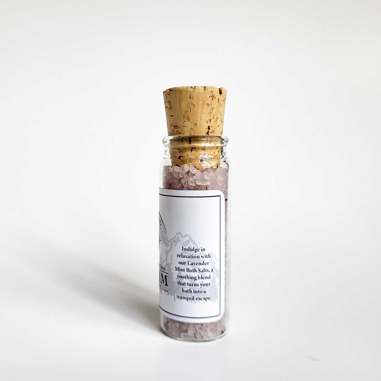 Sequim natural bath salts lavender mint scent in corked glass bottle displayed against a white backdrop showing description on label