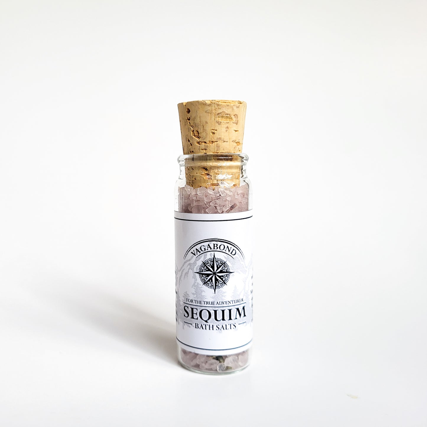 Sequim natural bath salts lavender mint scent in corked glass bottle displayed against a white backdrop showing logo on label