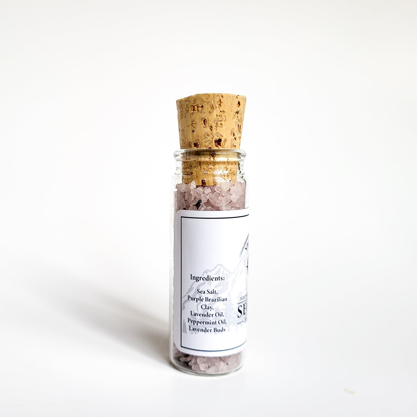 Sequim natural bath salts lavender mint scent in corked glass bottle displayed against a white backdrop showing ingredients on label