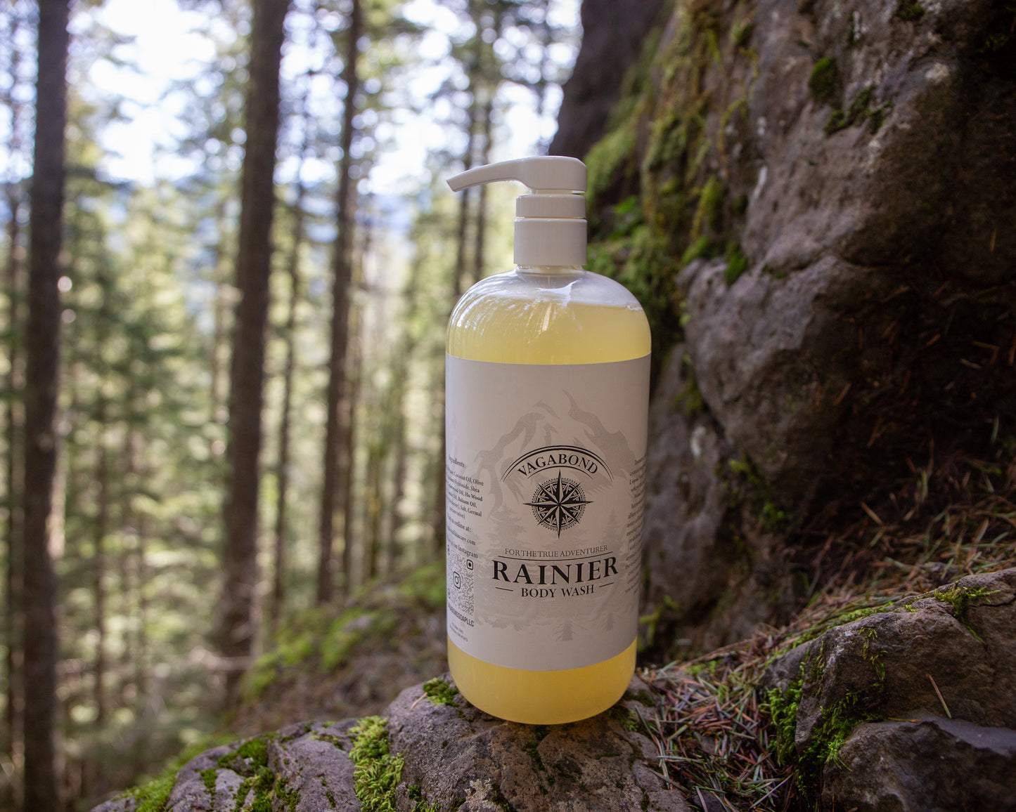 Rainier natural body wash warm cinnamon scent displayed against a mountainside backdrop