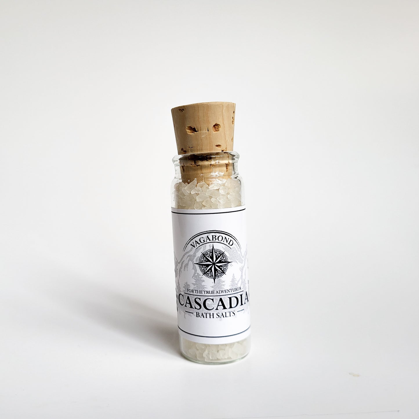 Cascadia natural bath salts lemon citrus scent in corked glass bottle displayed against a white backdrop showing logo on label