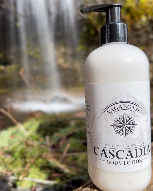 Cascadia natural lotion lemon citrus scent displayed against a blurry waterfall backdrop.