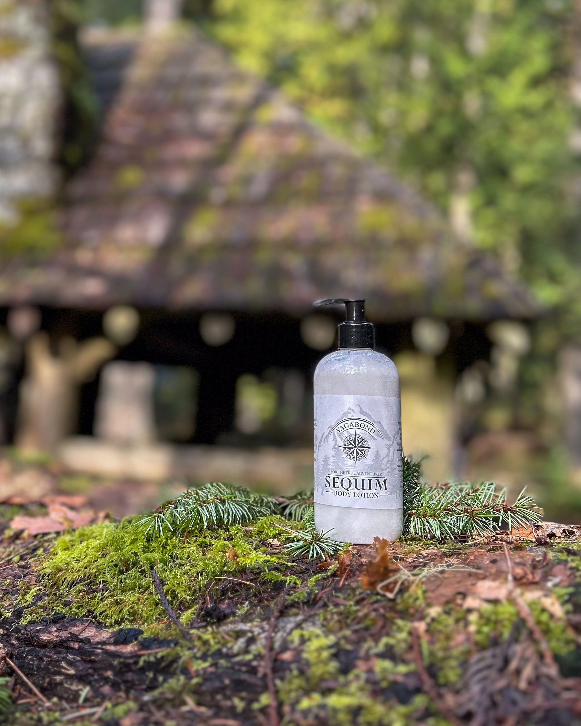 Sequim natural lotion lavender mint scent displayed against a blurry cabin backdrop.